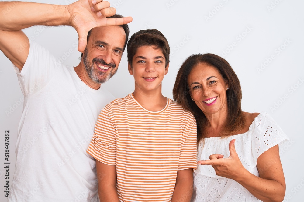 Family of three, mother, father and son standing over white isolated background smiling making frame with hands and fingers with happy face. Creativity and photography concept. Family of three, mother, father and son standing over white isolated background smiling making frame with hands and fingers with happy face. Creativity and photography concept.