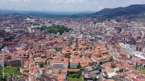 anoramic aerial view of Oviedo city surrounded by mountain ranges on sunny summer day, Asturias, Spain photo