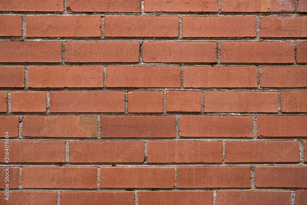 A textured background image of a red brick wall A textured background image of a red brick wall