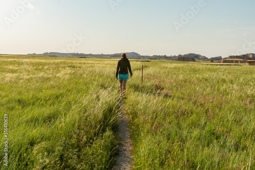 Woman Hikes Through Badlands