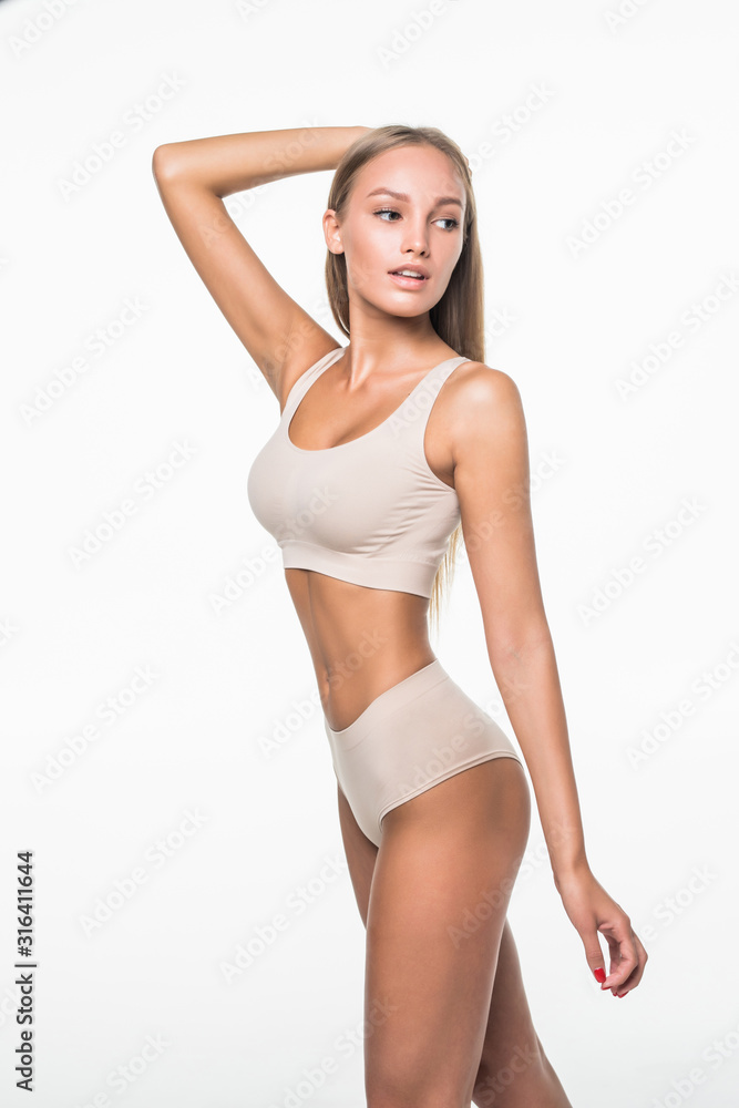 Slim tanned woman in beige underwear isolated over white background. Healthy lifestyles concept. Slim tanned woman in beige underwear isolated over white background. Healthy lifestyles concept.