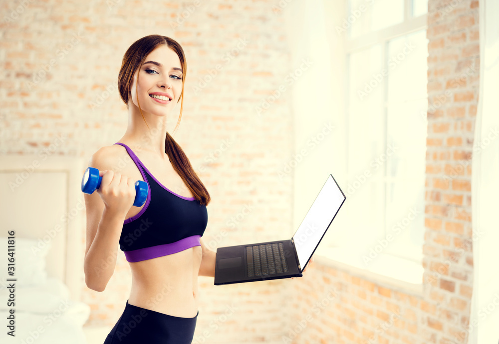 Happy smiling brunette girl in sportswear with notebook, doing fitness exercise with dumbbell, at home. Healthy lifestyle, weight lossing and sporting. Happy smiling brunette girl in sportswear with notebook, doing fitness exercise with dumbbell, at home. Healthy lifestyle, weight lossing and sporting.