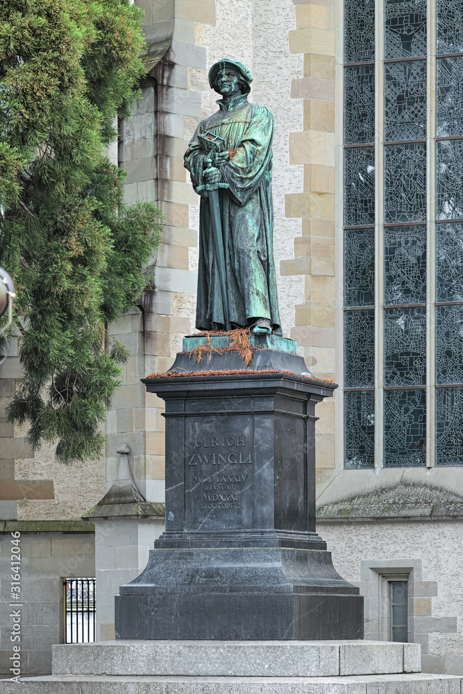 Zwingli Monument in front of the Wasserkirche (Water Church) in Zurich, Switzerland. The monument was erected in 1885. Text on the pedestal reads: ULRICH ZWINGLI January 1, 1484 - October 11, 1531.
