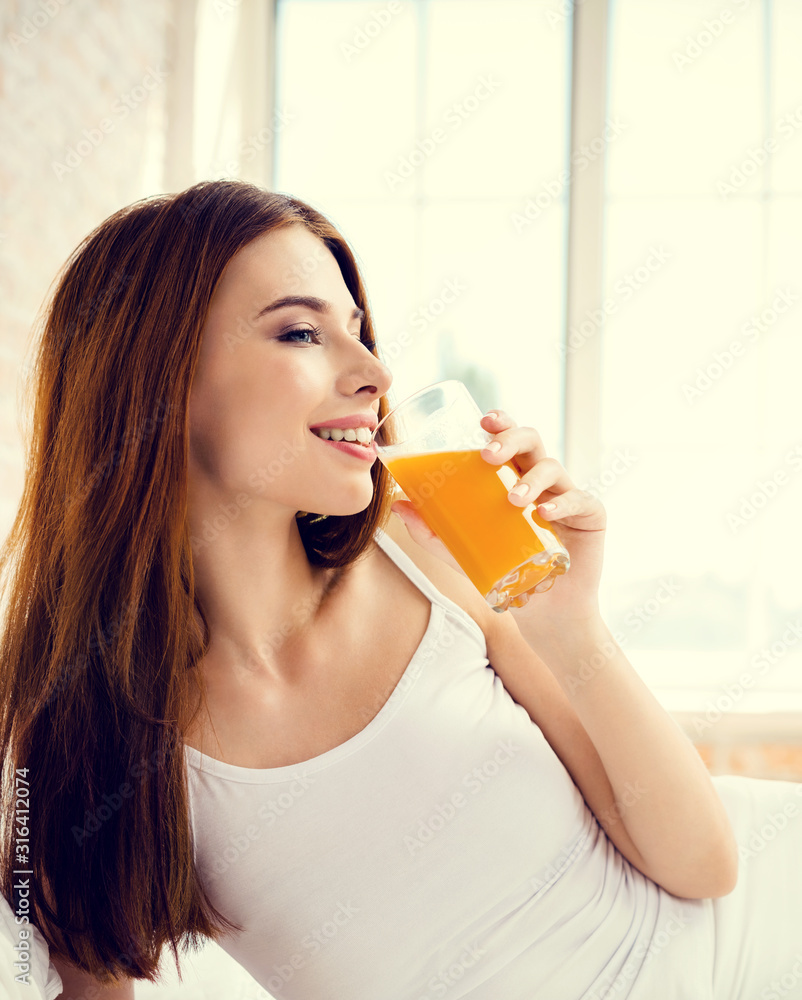 Portrait of beautiful brunette girl drinking orange juice at home. Healthy eating, beauty and dieting concept. Portrait of beautiful brunette girl drinking orange juice at home. Healthy eating, beauty and dieting concept.