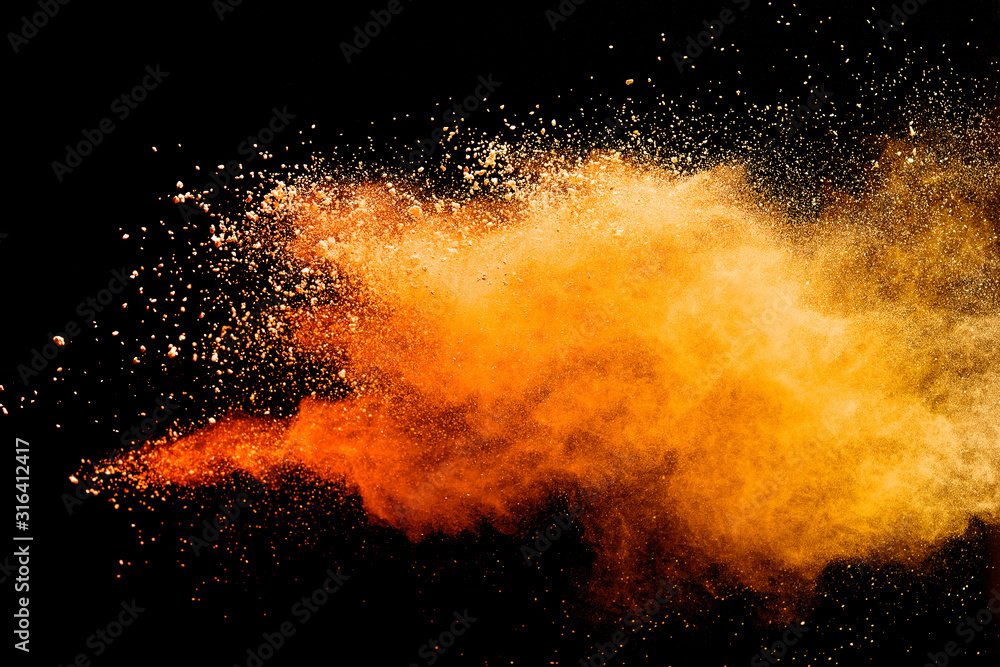 Fototapeta Abstract orange powder explosion isolated on black background.