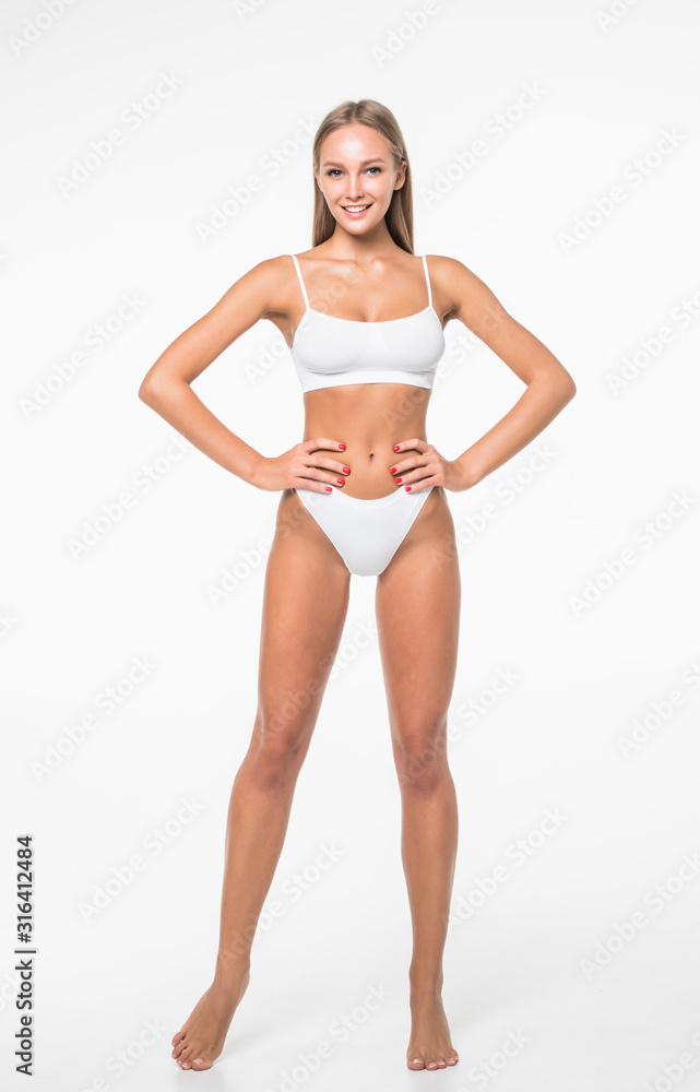 Happy young slim woman with beautiful perfect body posing on white  background. Full-length portrait Stock Photo