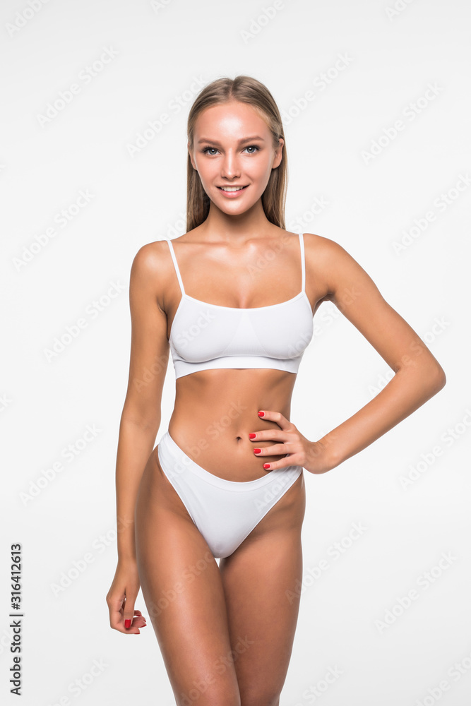 Young woman with beautiful slim perfect body in white bikini isolated white  background Stock Photo