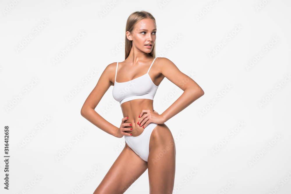 Woman with beautiful slim body posing in underwear on the white
