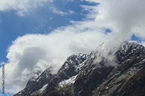 Clouds and mountains of the fjordland, Milford Sound, New Zealand, South Island