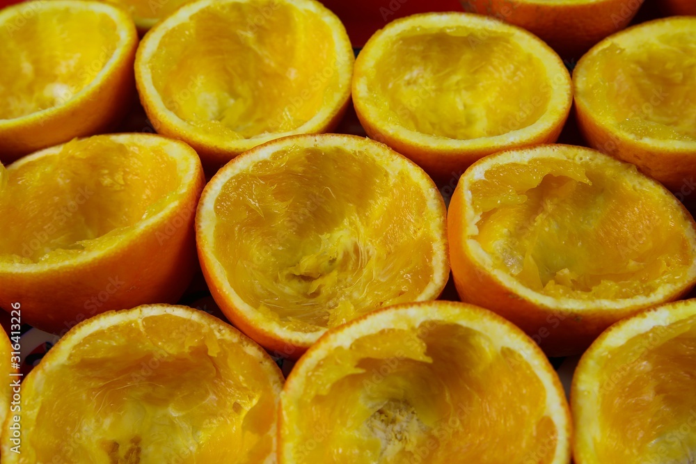 Freshly squeezed orange fruits juice concept: High angle top view on group pressed empty peel halves Freshly squeezed orange fruits juice concept: High angle top view on group pressed empty peel halves