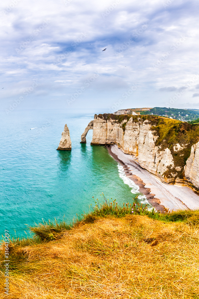 Naklejka premium Panorama of natural chalk cliffs of Etretat with visible arche and beach coastline, Normandy, France, Europe