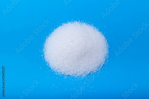 white granulated sugar on an blue background