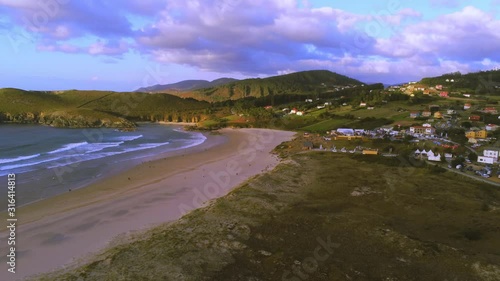 Wallpaper Mural Long sandy beach surrounded by idyllic green hills. Paradise beach, Pantin, Galicia Spain. Aerial wide shot Torontodigital.ca