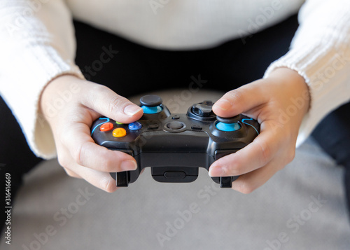 A person holding game controller playing video games