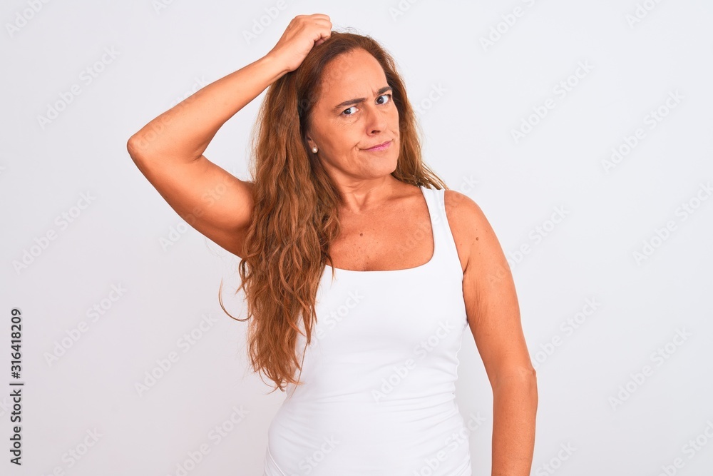 Middle age mature woman standing over white isolated background confuse and wondering about question. Uncertain with doubt, thinking with hand on head. Pensive concept. Middle age mature woman standing over white isolated background confuse and wondering about question. Uncertain with doubt, thinking with hand on head. Pensive concept.