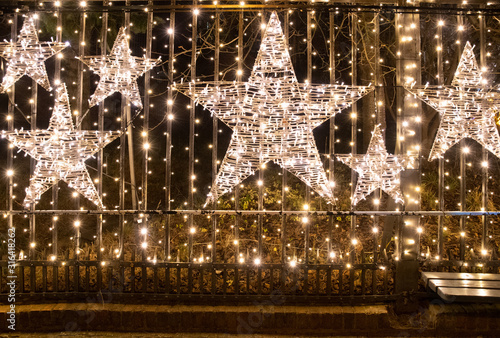 Photography Beautiful Christmas background with glowing stars and sparkling golden lights