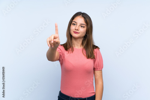 Young brunette girl over isolated blue background touching on transparent screen
