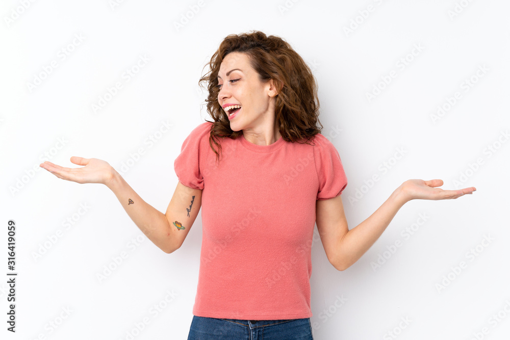 Young pretty woman over isolated background holding copyspace with two hands Young pretty woman over isolated background holding copyspace with two hands