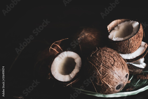 dark background\ coconuts on a leaf shaped plate photo