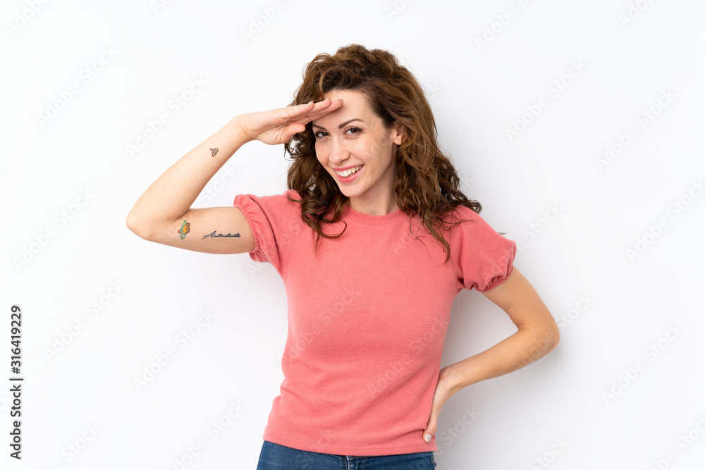Young pretty woman over isolated background looking far away with hand to look something Young pretty woman over isolated background looking far away with hand to look something