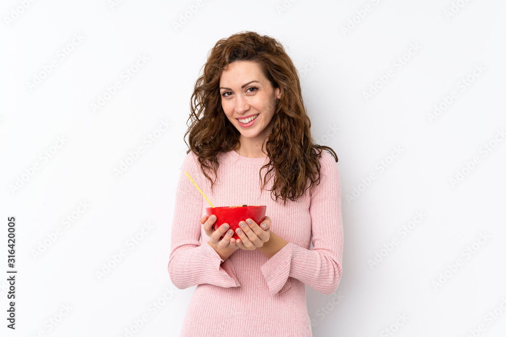 Young pretty woman over isolated background holding a bowl of cereals Young pretty woman over isolated background holding a bowl of cereals