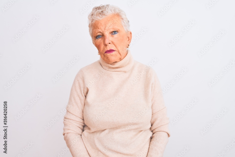 Senior grey-haired woman wearing turtleneck sweater standing over isolated white background looking sleepy and tired, exhausted for fatigue and hangover, lazy eyes in the morning. Senior grey-haired woman wearing turtleneck sweater standing over isolated white background looking sleepy and tired, exhausted for fatigue and hangover, lazy eyes in the morning.