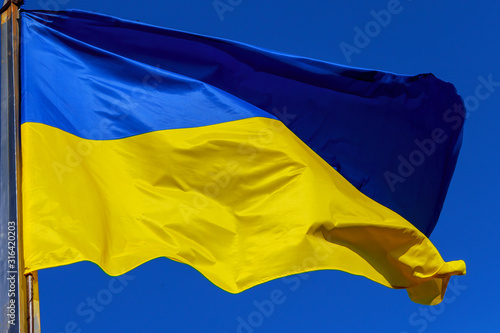 Ukrainian flag in the wind against the of the sky