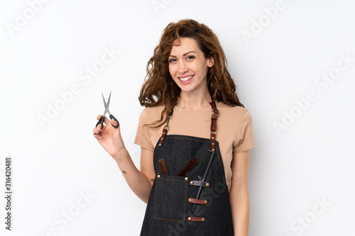 Young pretty woman over isolated background with hairdresser or barber dress