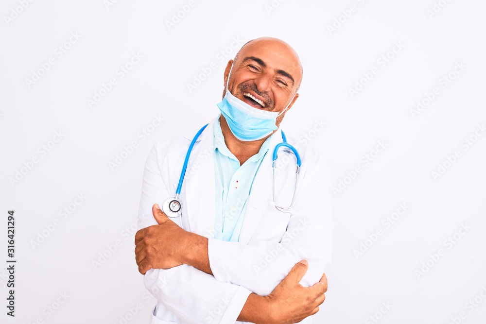 Middle age doctor man wearing stethoscope and mask over isolated white background happy face smiling with crossed arms looking at the camera. Positive person. Middle age doctor man wearing stethoscope and mask over isolated white background happy face smiling with crossed arms looking at the camera. Positive person.