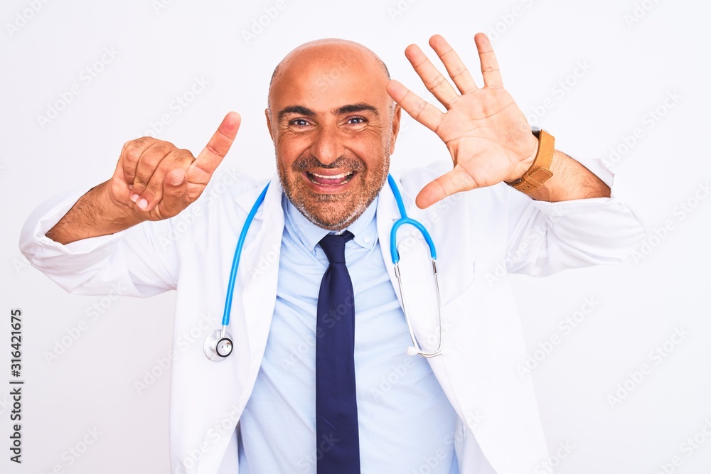 Middle age doctor man wearing stethoscope and tie standing over isolated white background showing and pointing up with fingers number six while smiling confident and happy. Middle age doctor man wearing stethoscope and tie standing over isolated white background showing and pointing up with fingers number six while smiling confident and happy.