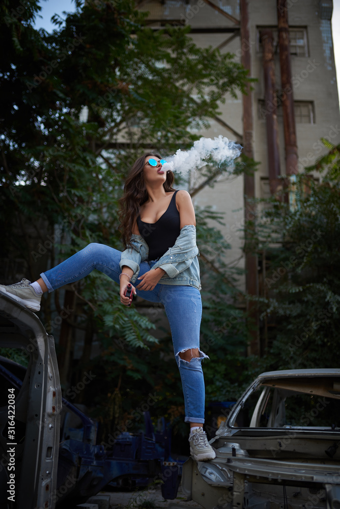 Vaping. Young beautiful woman vaping . Vapor concept.