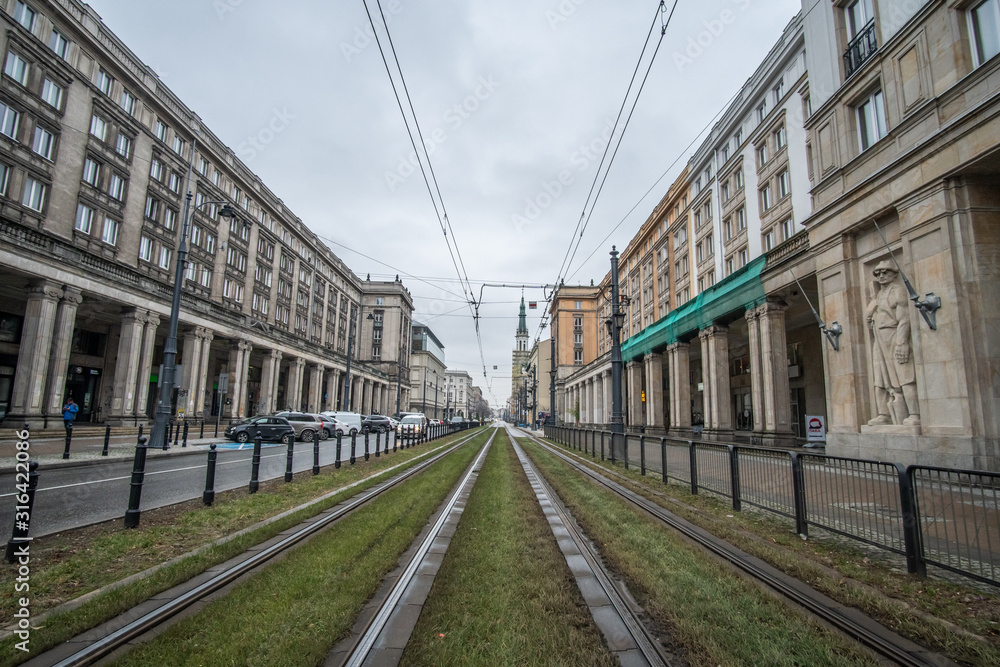 Warsaw, Poland - January 2020: Empty street with tram line in central Warsaw among Stalinist architecture buildings