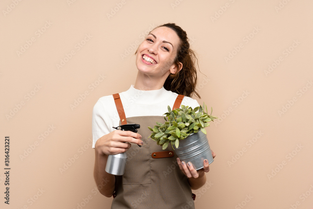 Gardener woman holding a plant