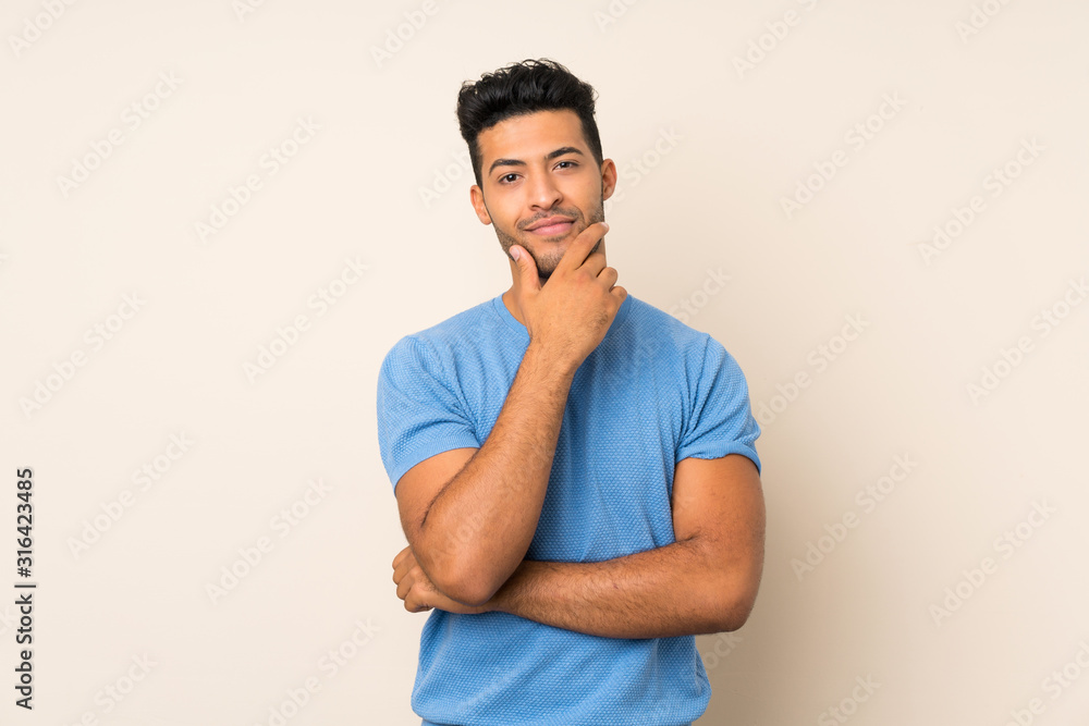 Young handsome man over isolated background thinking Young handsome man over isolated background thinking