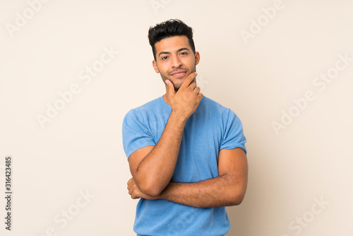 Young handsome man over isolated background thinking