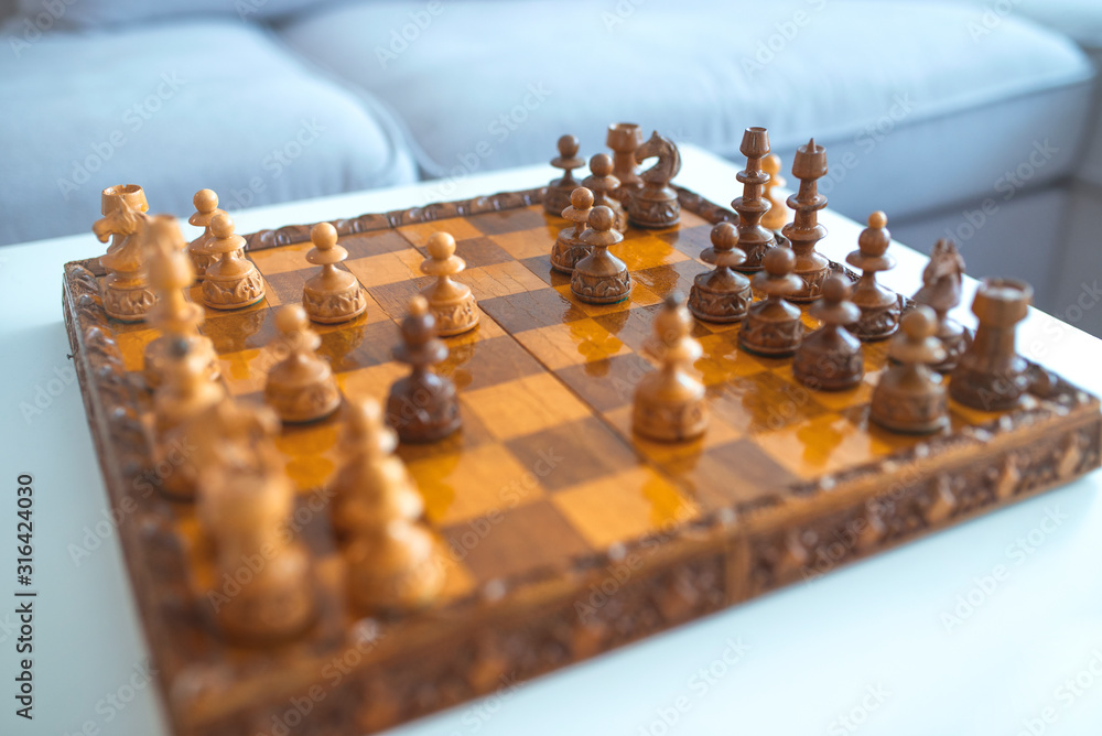 Wood chess pieces on board game. Bright background. Photography of a chess Board and chess pieces, Wooden chess pieces on a chess Board. Chess board game, strategy and competition in business concept.