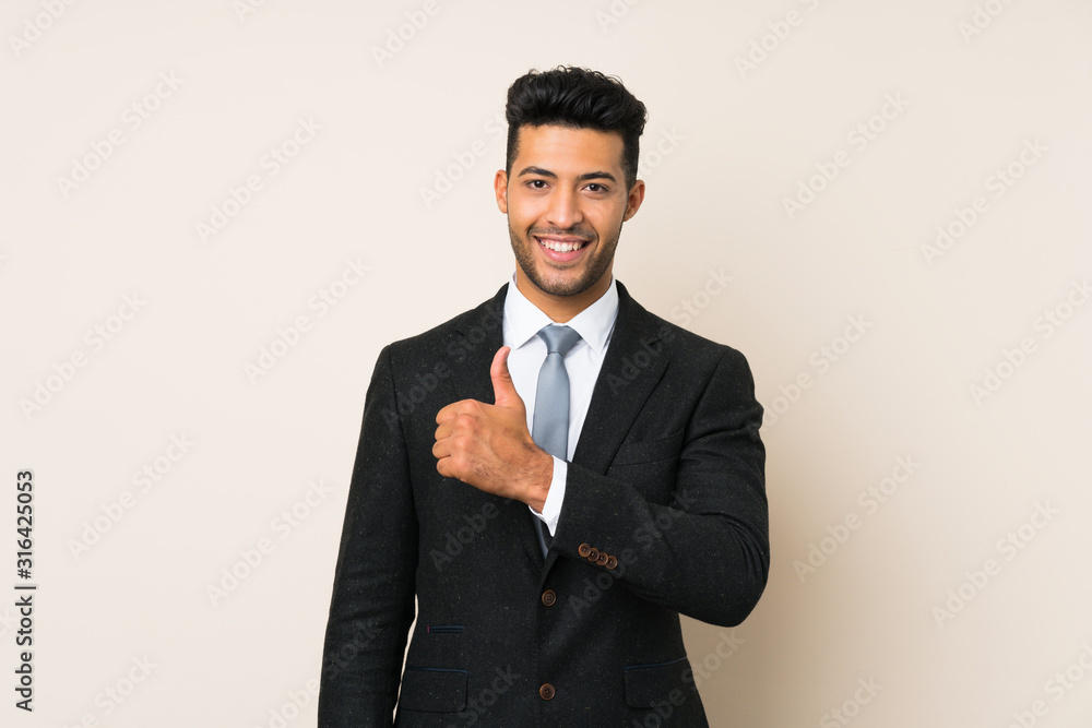Young handsome businessman man over isolated background giving a thumbs up gesture Young handsome businessman man over isolated background giving a thumbs up gesture