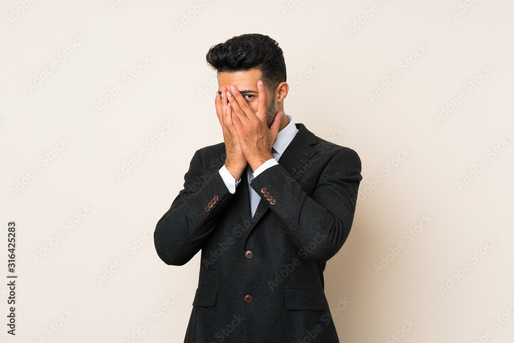 Young handsome businessman man over isolated background covering eyes and looking through fingers Young handsome businessman man over isolated background covering eyes and looking through fingers