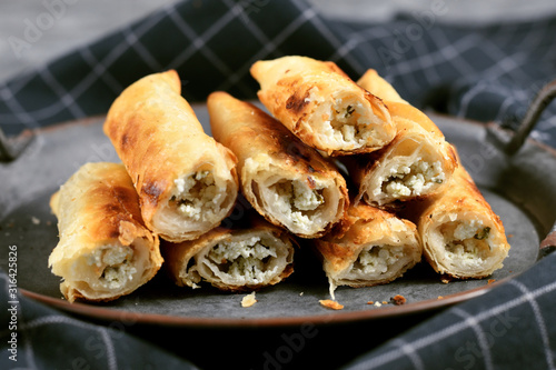 Fresh baked 'Börek', a baked filled pastries made of a thin flaky dough filled with sheep milk cheese from treditional Balkan cuisine photo