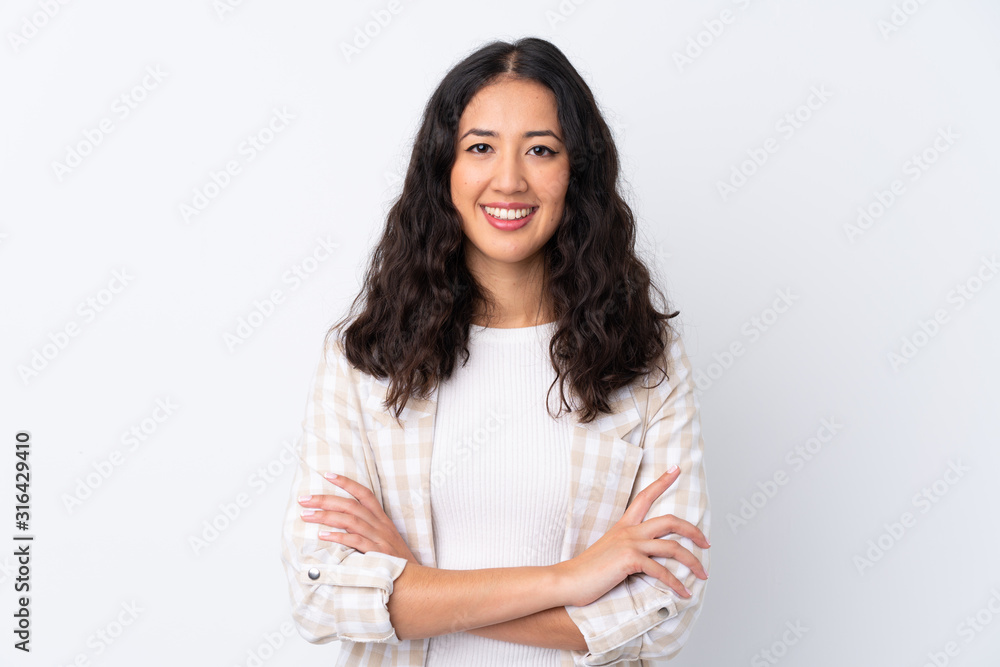 Mixed race woman over isolated white background keeping the arms crossed in frontal position