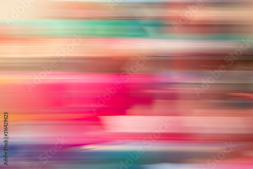 Yellow blue red colorful abstract background consisting of horizontal blur stripes