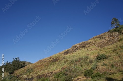 Road in the mountain and mountain view with blue sky and green trees 