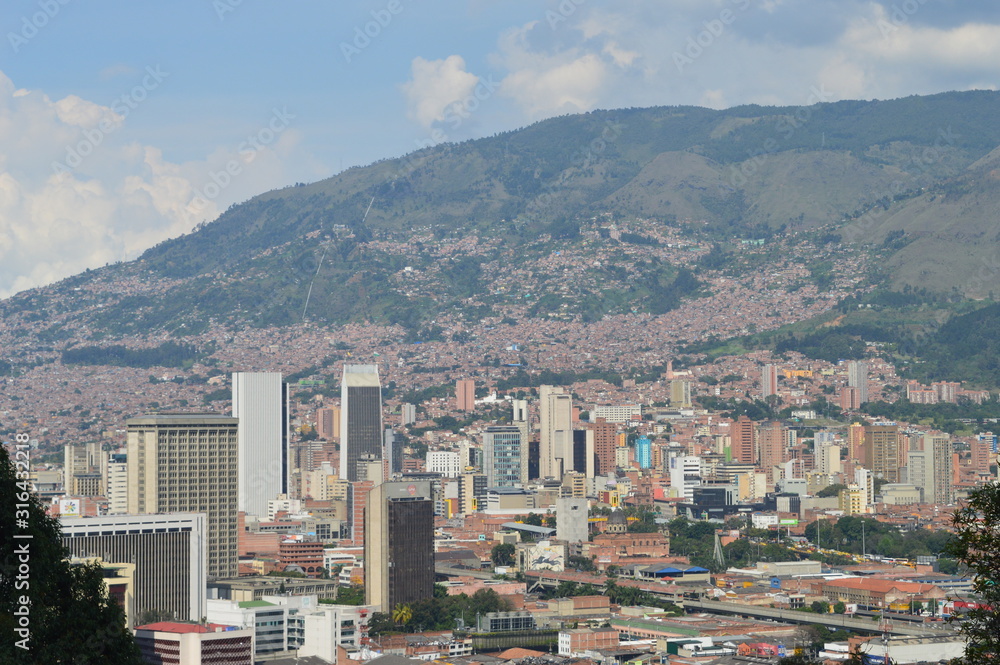 topview of medellin city, colombia, with buildings and shanty towns. contrast between poor and rich