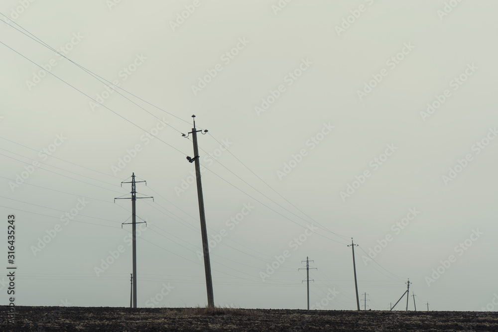 Power lines, cloudy days, empty fields
