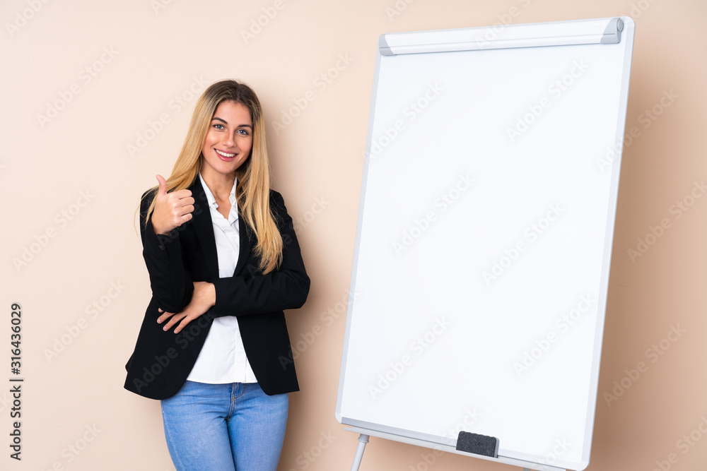Young Uruguayan woman giving a presentation on white board and with thumbs up Young Uruguayan woman giving a presentation on white board and with thumbs up