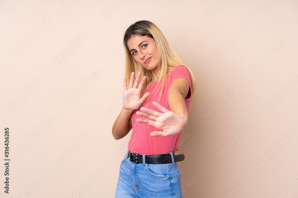 Young Uruguayan woman over isolated background nervous stretching hands to the front Young Uruguayan woman over isolated background nervous stretching hands to the front