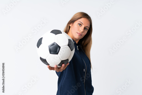 Young football player woman over isolated white background © luismolinero