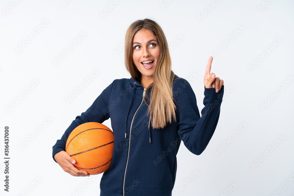 Young woman playing basketball over isolated white background Young woman playing basketball over isolated white background