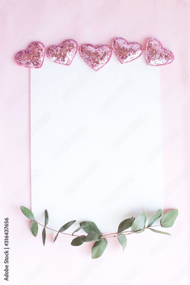 Background with copy space blank on pink background with pink glittered hearts, eucalyptus branch. White paper top view, flat lay, minimal style. Moke up card.