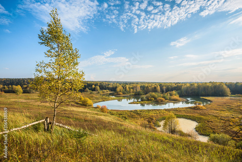 Beautiful panoramic view from above of the river valley and meadows in autumn on a Sunny day.